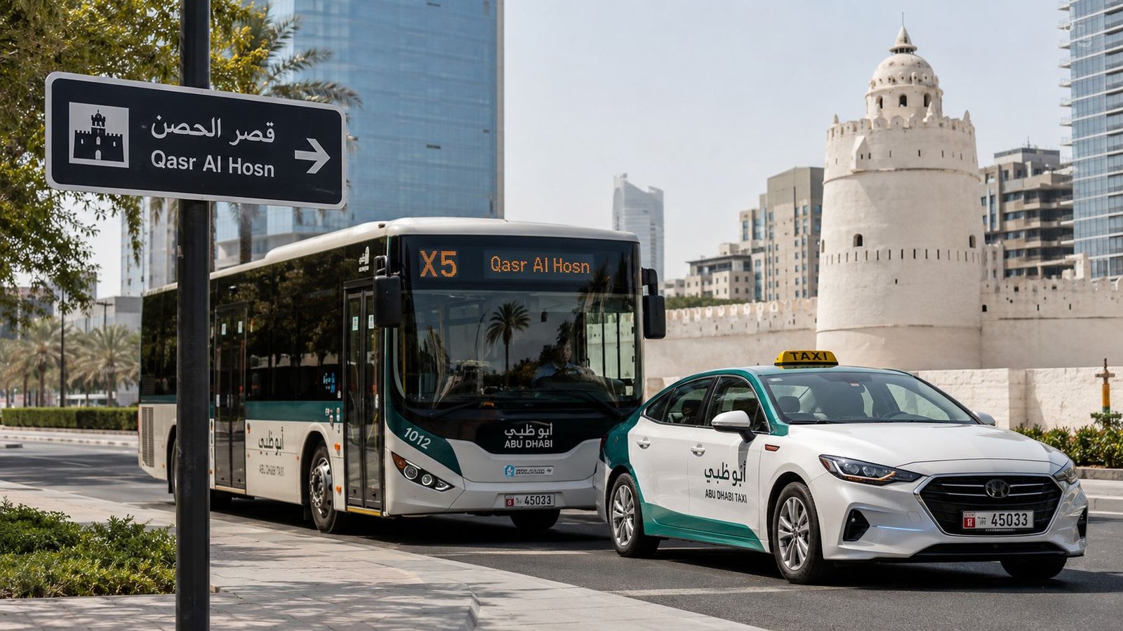 A bus and an Abu Dhabi taxi driving near the historic Qasr Al Hosn landmark area.