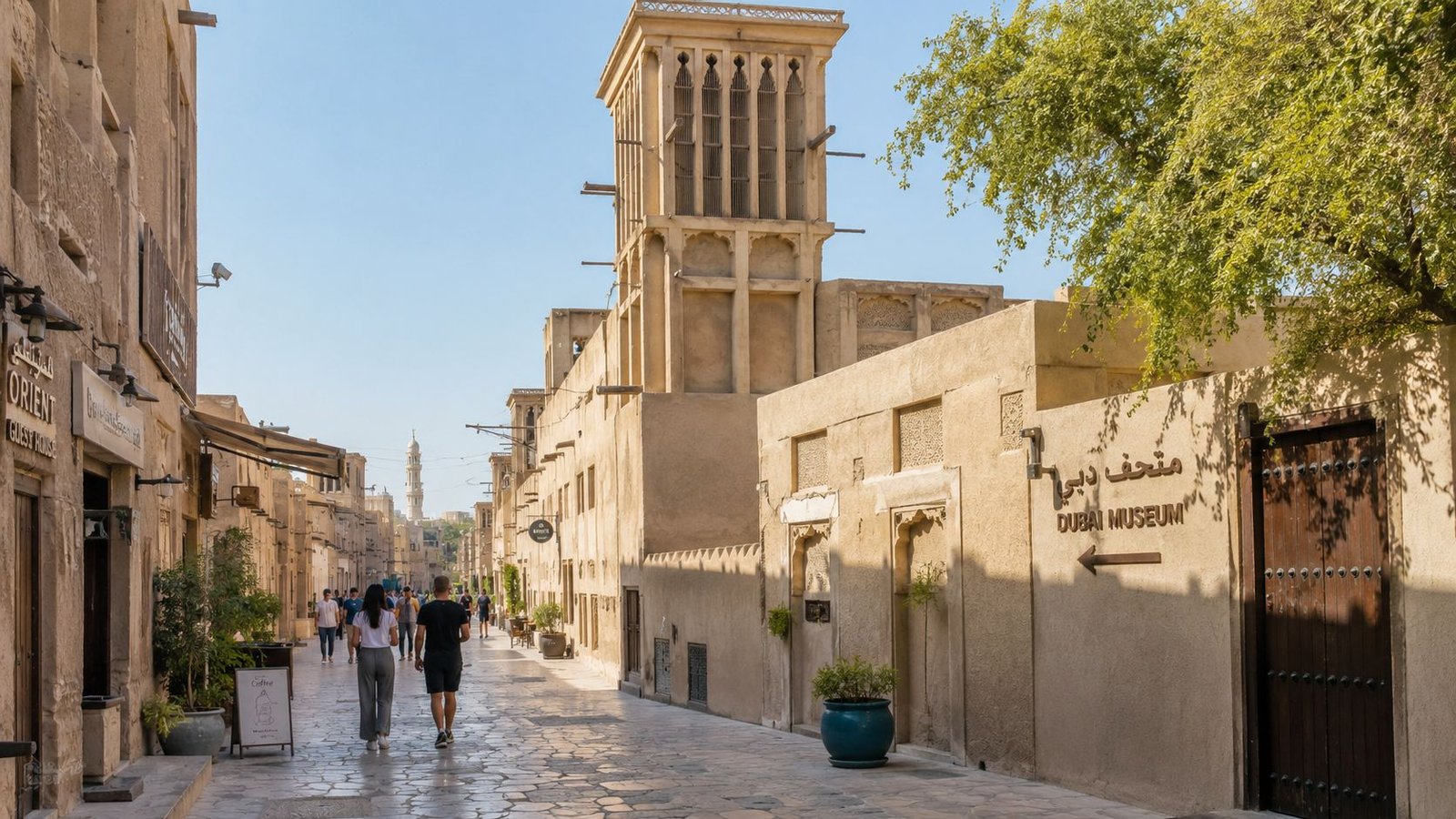 Pedestrians walking through a historic street in the Al Fahidi Historical Neighborhood of Dubai near the museum.